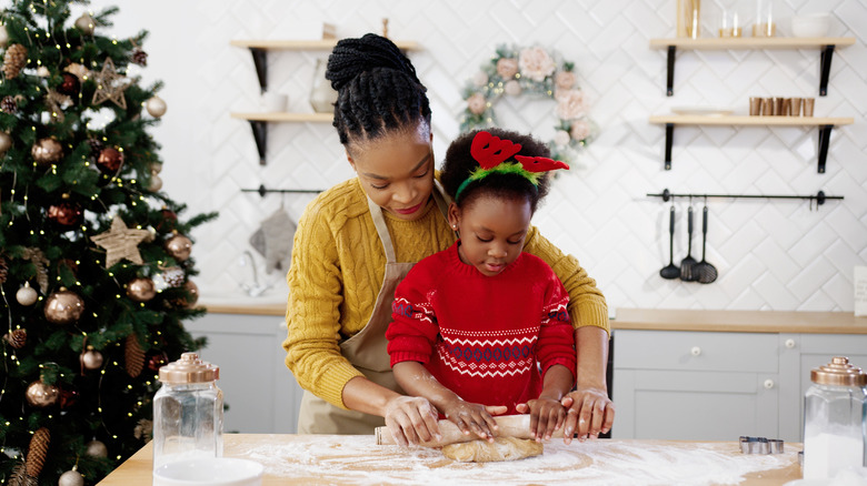 mother and daughter baking christmas cookies