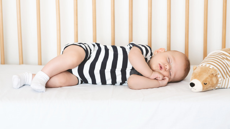 Baby napping in a crib